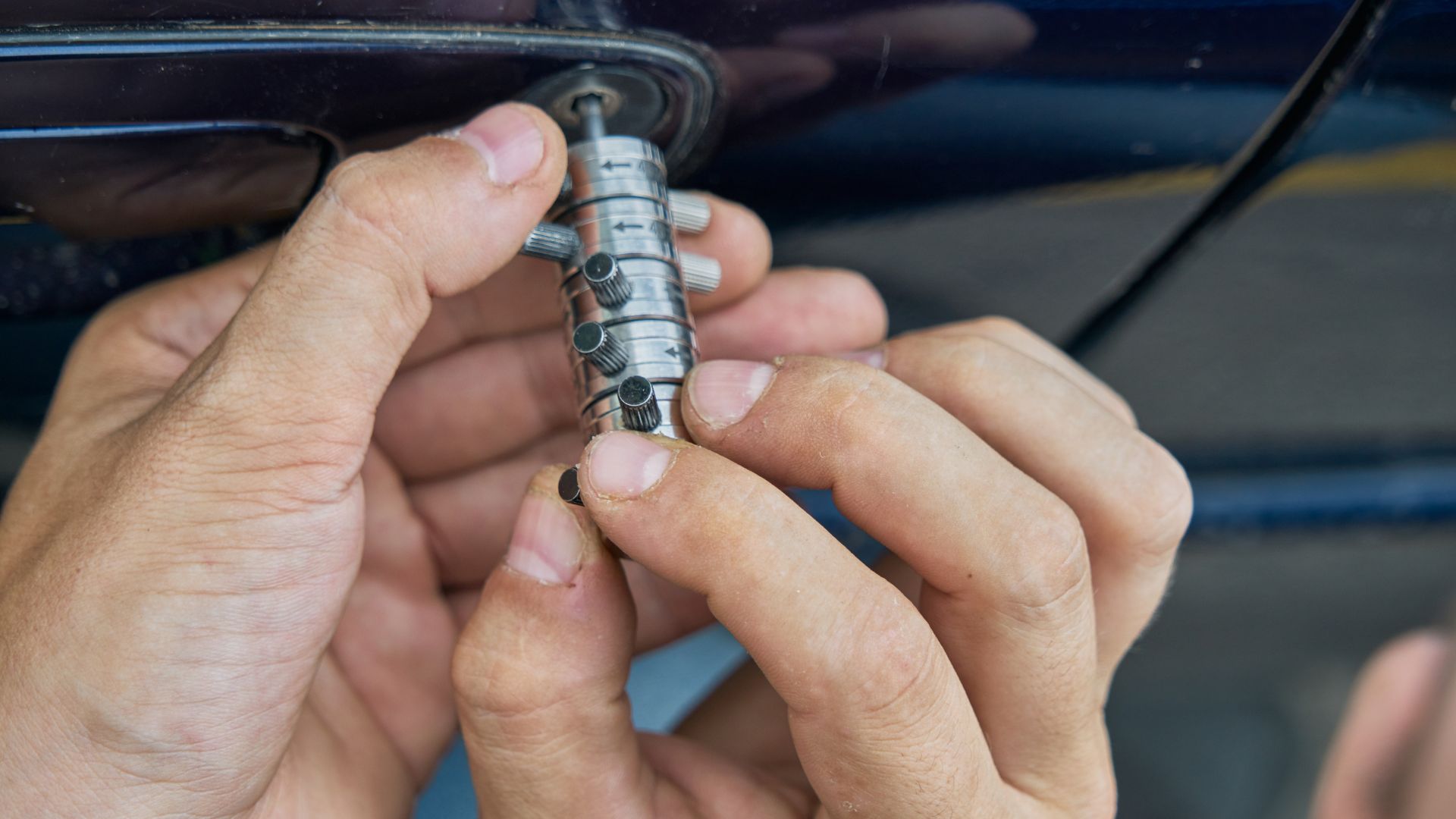 A person holding a small metal object in their hands
