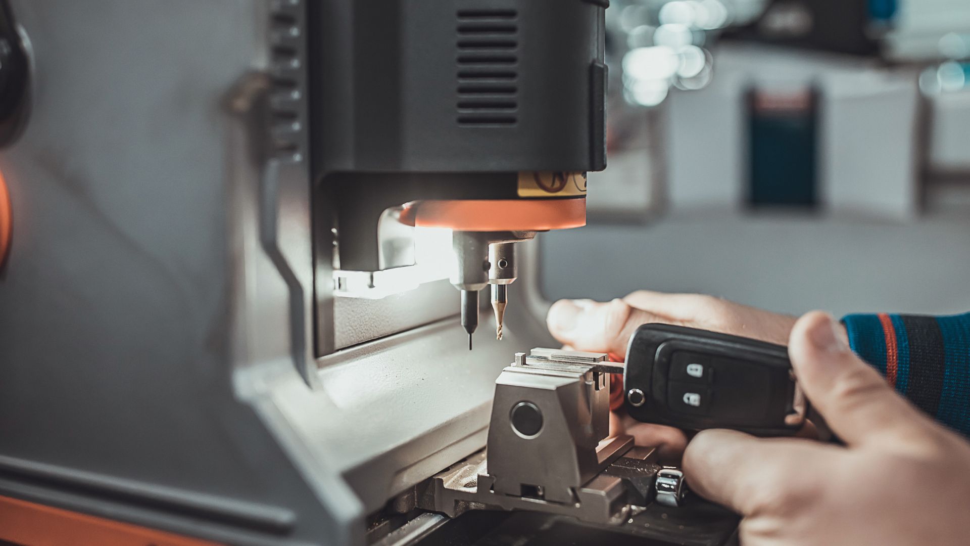 A person using a cell phone to operate a machine